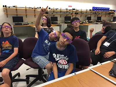 Students doing an experiment with glasses.